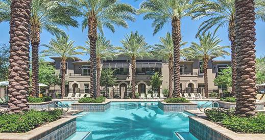 Mediterranean-style estate with turquoise pool and palm trees at Diamante Community